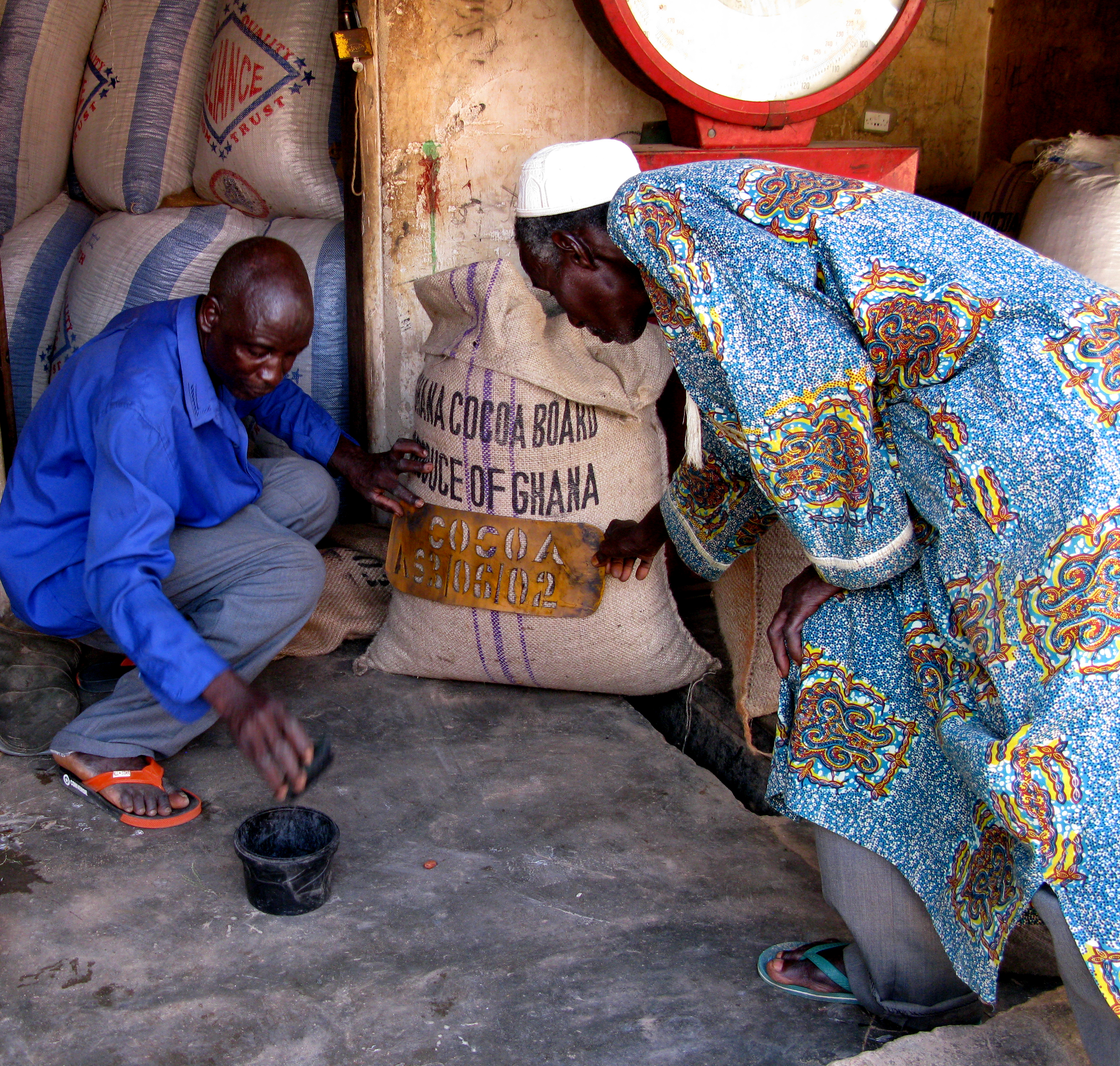 the recorders stamping the sacks of cocoa